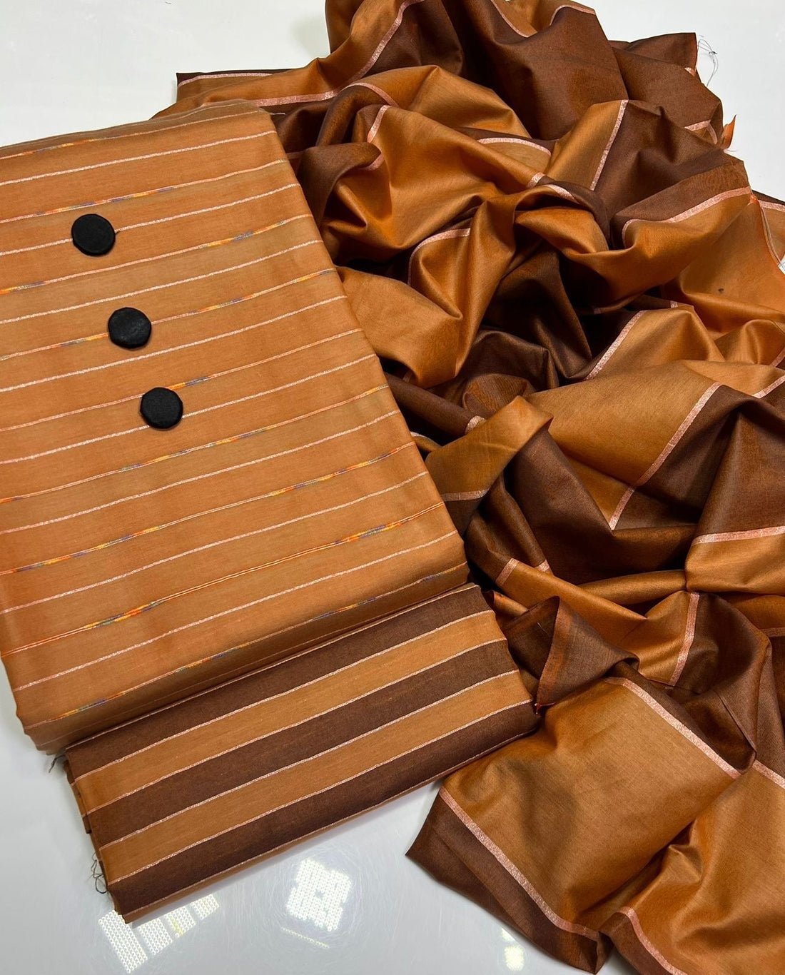 Unstitched 3 PC Royal Essence Lawn
(Golden Brown)